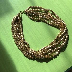 Torsade Gold-tone. 6 strand. Spring ring clasp.